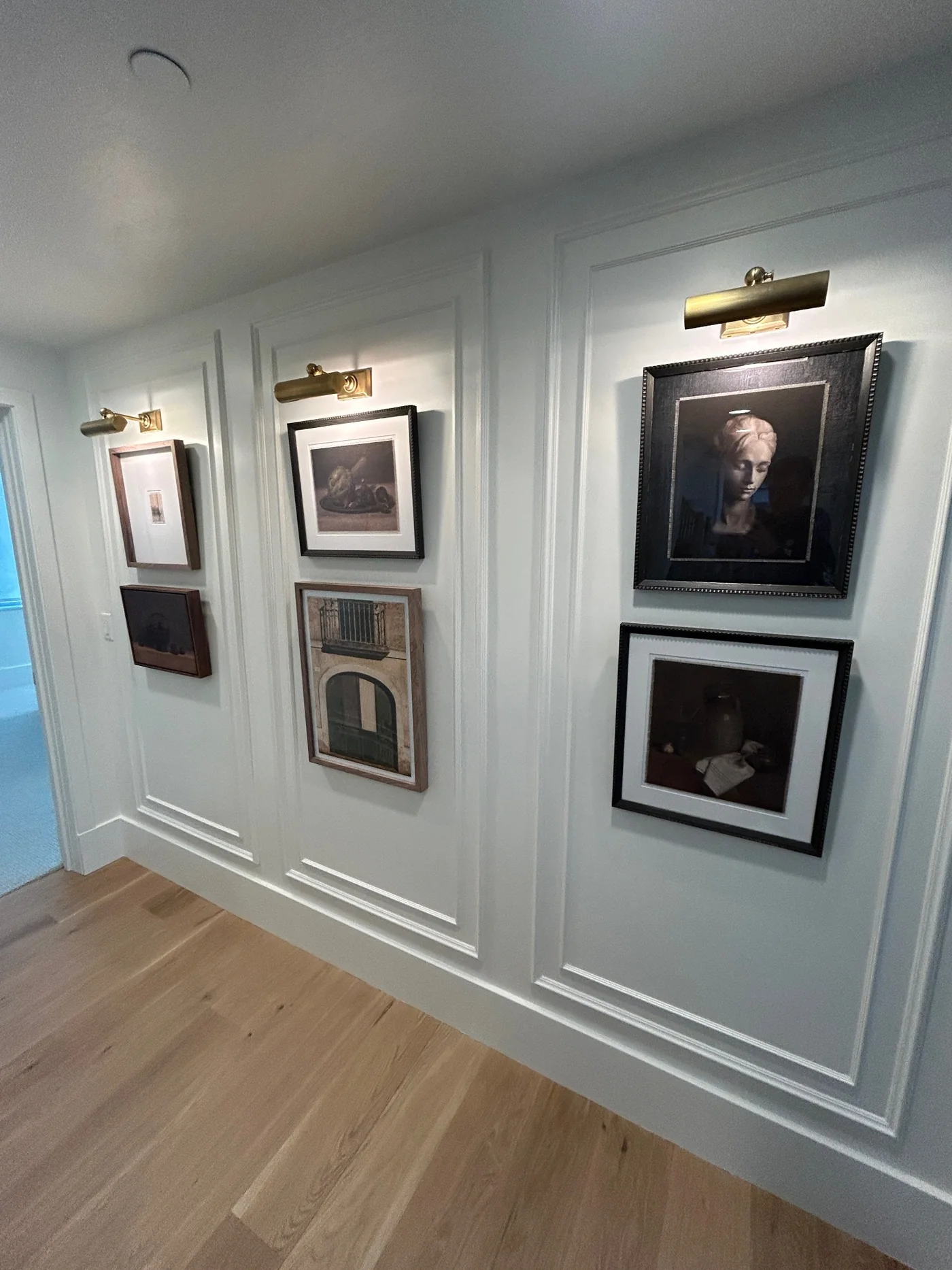 Framed artwork installed in three architectural wall panels