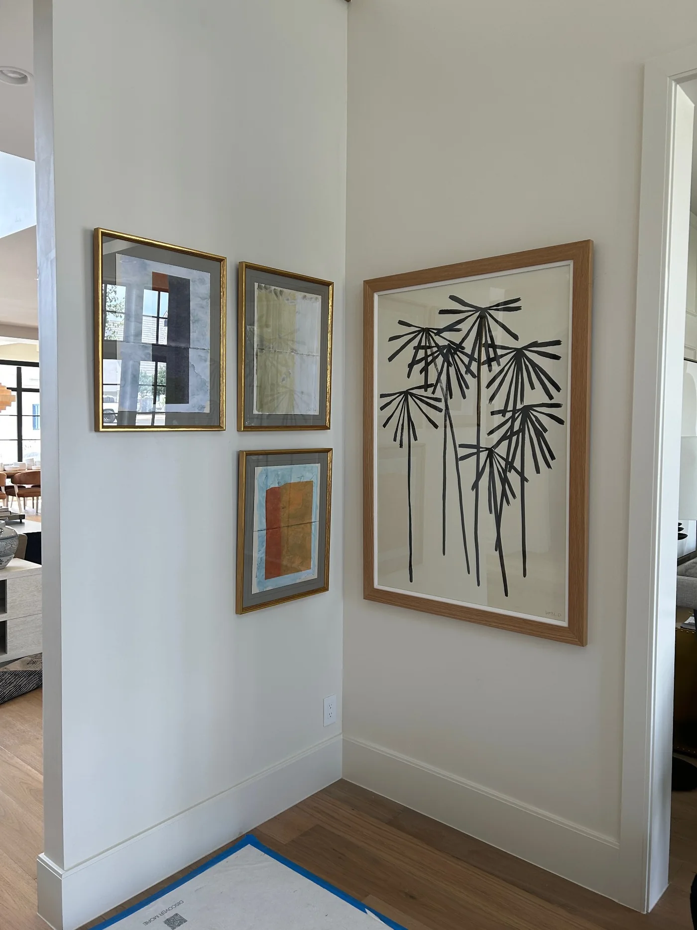 Modern framed artwork arranged across adjoining walls